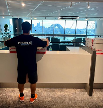 removalist carrying box in an office
